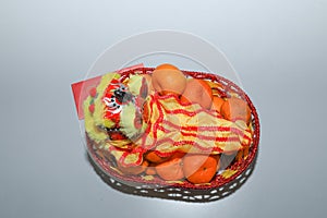 Chinese New Year, orange fruit basket with Chinese Dragon and angpao facing left close up