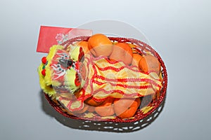 Chinese New Year, orange fruit basket with Chinese Dragon and angpao top view close up