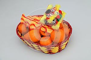 Chinese New Year, orange fruit basket with Chinese Dragon close up