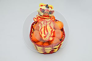 Chinese New Year, orange fruit basket with Chinese Dragon close up