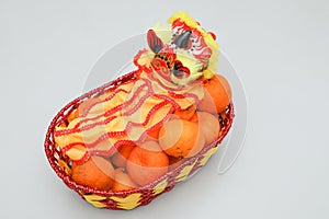 Chinese New Year, orange fruit basket with Chinese Dragon facing right close up