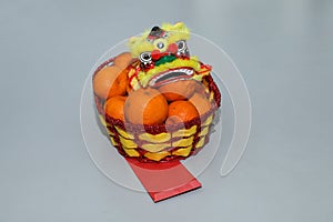 Chinese New Year, orange fruit basket with Chinese Dragon front view close up