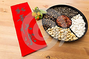 Chinese new year snack tray and chinese calligraphy, meaning for