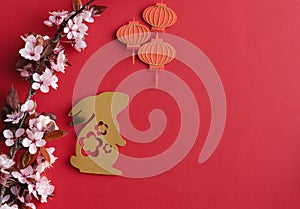 Chinese New Year, year of the rabbit. Year 2023 with golden rabbit and plum blossom fans. Copy space.