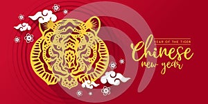 Chinese new year , year of the tiger with gold paper cutting head tiger zodiac sign and white clude and flower on red background