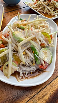 Chinese noodle mix spicy papaya salad it called Tam Sua