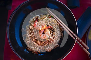 Chinese noodles with shrimps on the table photo
