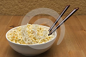 Chinese noodles on the wooden table in a white plate
