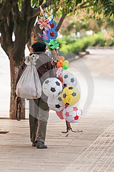 Chinese old man street vendor seller ball and other toys on the