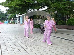 Chinese older women are playing Tai Chi