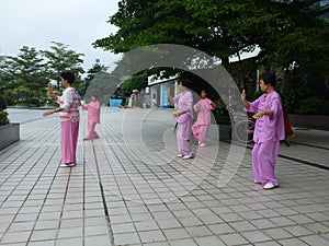 Chinese older women are playing Tai Chi