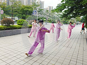 Chinese older women are playing Tai Chi