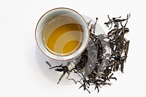 Chinese oolong tea soup and tea leaves on white background.