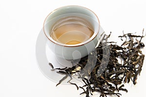 Chinese oolong tea soup and tea leaves on white background.