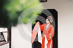 Chinese opera woman.Practicing Peking Opera in the garden With a red umbrella, Colorful, china
