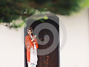 Chinese opera woman.Practicing Peking Opera Hand in a fan By the door , Colorful, china