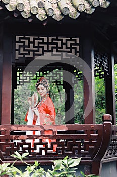 Chinese opera woman.Practicing Peking Opera in the Pavilion garden, Hand in a fan , Colorful, china