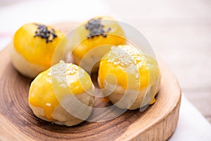 Chinese pastry bakery topping with black and white sesame  seeds on wooden tray