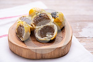 Chinese pastry bakery topping with black and white sesame  seeds on wooden tray