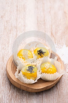 Chinese pastry bakery topping with black and white sesame  seeds on wooden tray ,top view