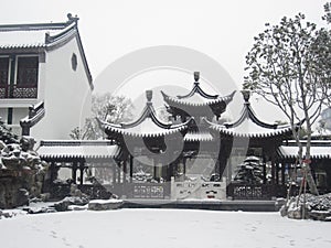 Chinese pavilion with falling snow