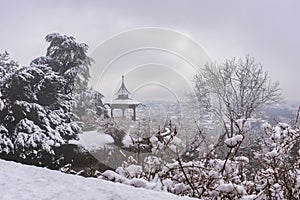 Chinese Pavilion on Schlossberg in town Graz on foggy winterday