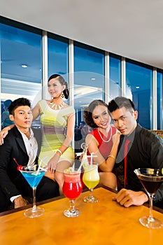 Chinese people drinking cocktails in luxury cocktail bar