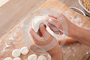 Chinese people make dumplings in the kitchen before traditional festivals