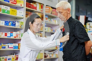 Chinese pharmacy woman with patient