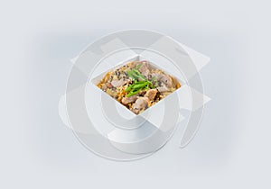 Chinese pork rice in white carton takeaway delivery box. Isolated on background