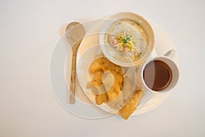 Chinese porridge in a bowel with chinese breadstick as breakfast