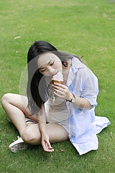 Chinese Portrait of young happy woman eating ice-cream