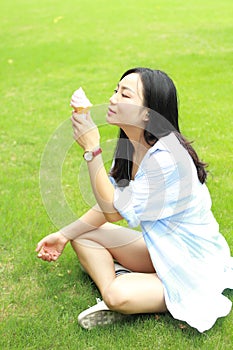 Chinese Portrait of young happy woman eating ice-cream