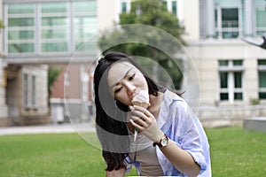 Chinese Portrait of young happy woman eating ice-cream