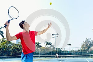 Chinese tennis player ready to hit the ball while serving