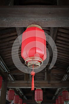 Chinese red lantern hanging from wooden crossbeam for Chinese new year