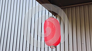 A Chinese red paper lantern in front of restaurant