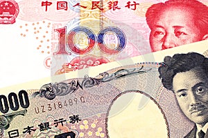 A Chinese renminbi one hundred yuan note with a Japanese yen bank note close up