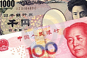 A Chinese renminbi one hundred yuan note with a Japanese yen bank note close up