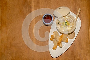 Chinese rice congee with Chinese breadstick and tea as a b