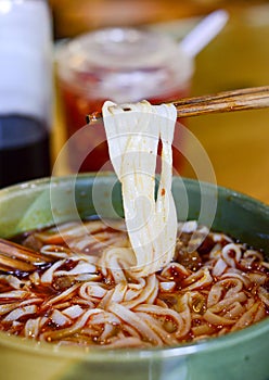 Chinese rice noodle soup with red chili oil
