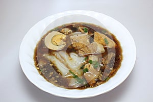 Chinese roll noodle soup with crunchy pork, egg and cinnamon