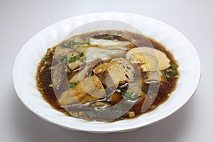 Chinese roll noodle soup with crunchy pork, egg and cinnamon