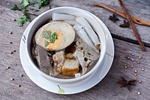 Chinese roll noodle soup on wood background