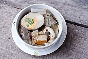Chinese roll noodle soup on wood background