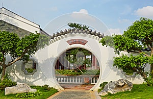 Chinese round gate in backyard landscaping garden