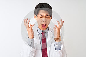 Chinese scientist man wearing tie and coat standing over isolated white background celebrating mad and crazy for success with arms