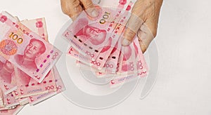 Chinese Senior woman counting money for payment