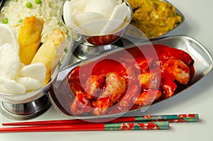 Chinese set,  chicken curry, sweet and sour chicken served with egg fried rice, vegetable spring rolls, and prawn crackers