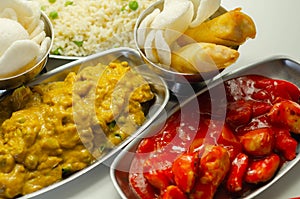 Chinese set,  chicken curry, sweet and sour chicken served with egg fried rice, vegetable spring rolls, and prawn crackers